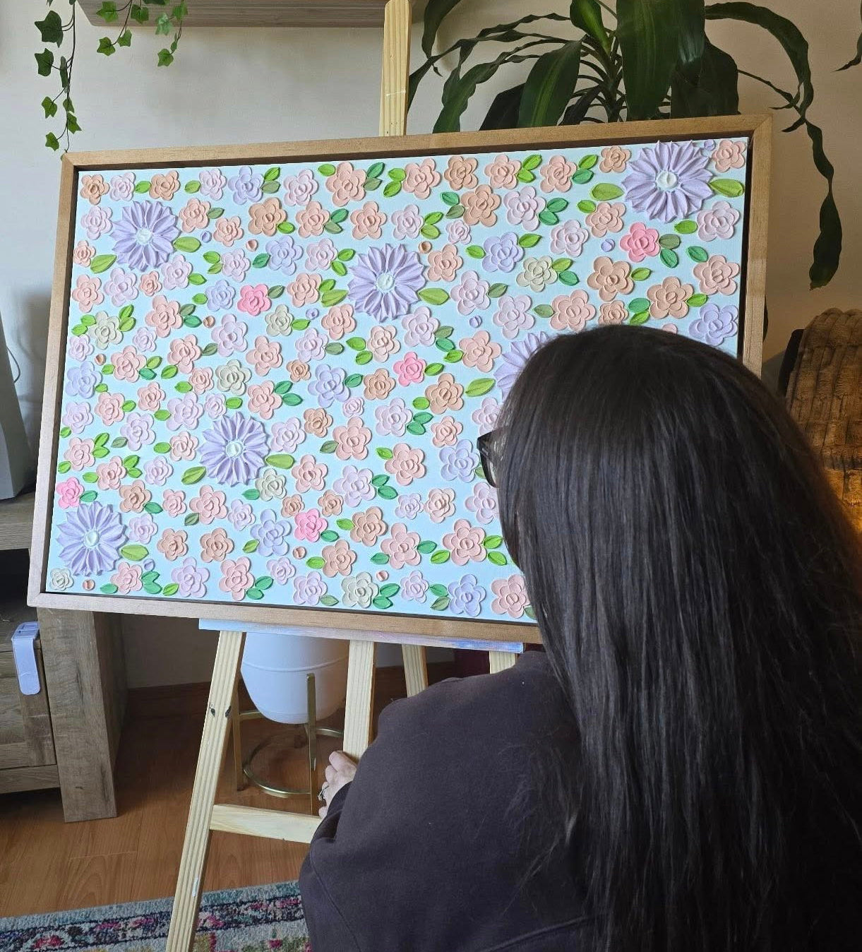 artist with her pastel colored artwork