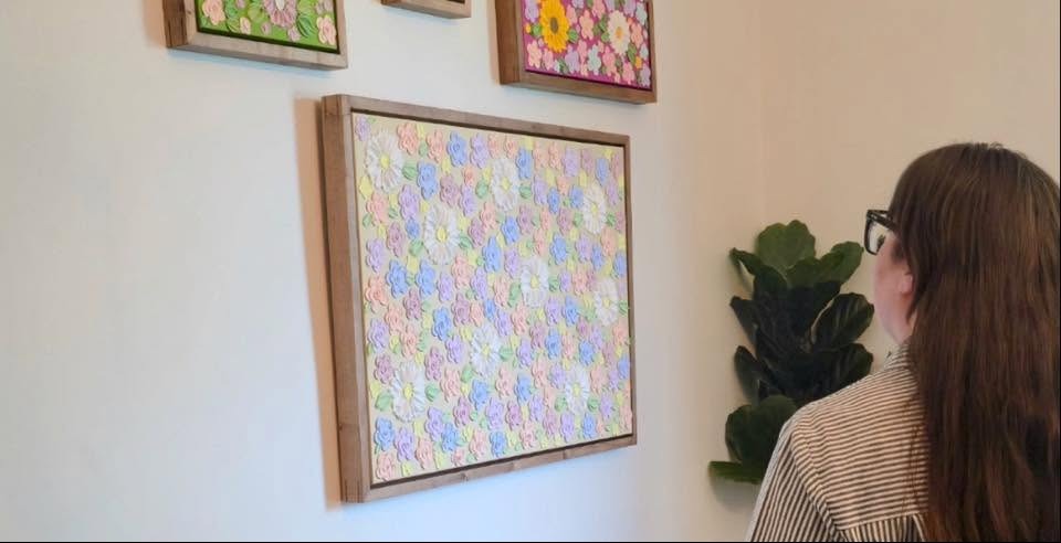 artist viewing artwork on wall